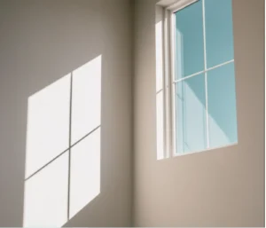 Sunlight shining through a clean residential window, illustrating how proper drainage and home maintenance help protect interior spaces from water damage.