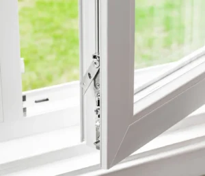 Close-up of a perfectly clean and open white vinyl window frame and lock mechanism, showing streak-free glass from professional window cleaning.
