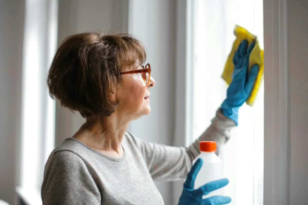 Homeowner cleaning interior residential glass in Toronto, illustrating common window cleaning mistakes to avoid.