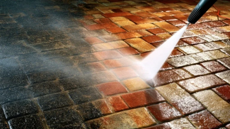 Pressure washing an interlocking paver driveway to remove dirt and surface buildup
